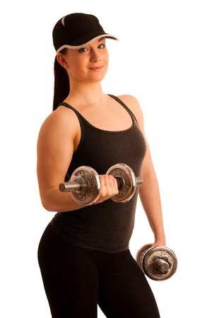 A young woman wearing a baseball cap and training clothes holding two hand weights